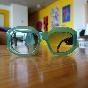 Green frame statement sunglasses